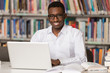 © Jale Ibrak - Happy African Male Student With Laptop In Library