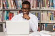 © Jale Ibrak - Happy African Male Student With Laptop In Library