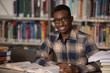 © Jale Ibrak - African Man Studying In A Library