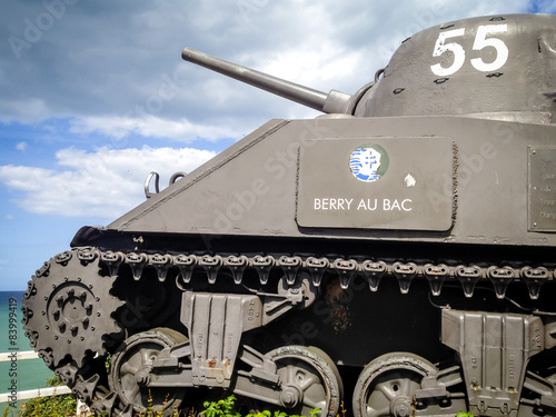 Poster old tank used in WWII in Arromanches, monument to Allied troops