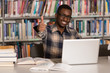 © Jale Ibrak - African Man In A Library Showing Thumbs Up