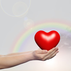 Wall Mural - Human hand with heart and rainbow