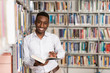 © Jale Ibrak - Happy Male Student With Book In Library