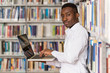 © Jale Ibrak - Happy Male Student With Laptop In Library