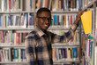 © Jale Ibrak - Happy Male Student With Book In Library