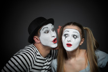 Male Mime Sharing Secret With Surprised Female Mime