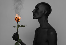 A Man With Black Skin Holding A Burning Rose, Black Death