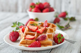 Fototapeta  - Belgium waffles with strawberries and mint on white plate
