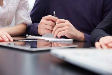 hand a group of businessmen on a table with a tablet, mobile pho