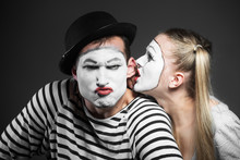 Female Mime Sharing Secret With Angry Male Mime