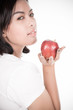 © Nonwarit - Smiling woman with apple isolated on white