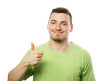 © Raisa Kanareva - young man in green shirt  showing thumbs up.