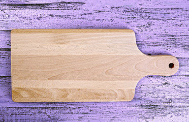 Cutting board on wooden background