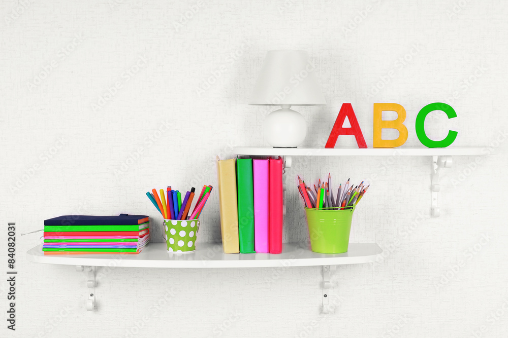 Shelves with stationery in child room close-up