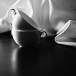Two cups on the table and tablecloth in black&white