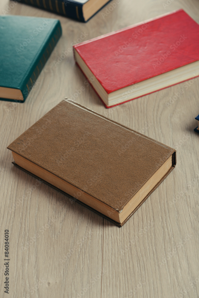 Heap of books on wooden background