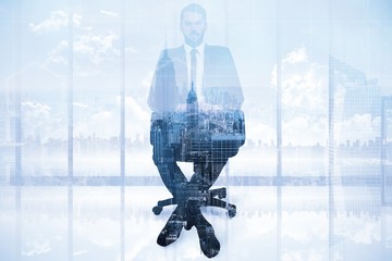 Poster - Composite image of stern businessman sitting on an office chair 