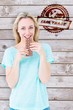 © WavebreakMediaMicro - Composite image of smiling blonde eating bar of chocolate