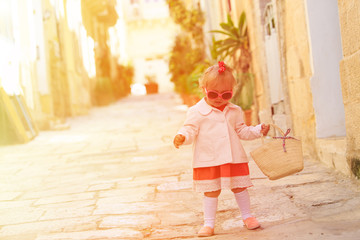 cute little girl walking in the city