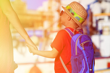 mother and son holding hands in the port