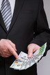 © zest_marina - Unrecognizable businessman holding dollars and euro