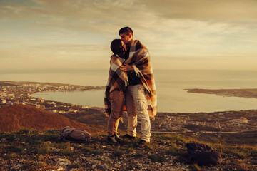 Wall Mural - Loving couple standing outdoor at sunset