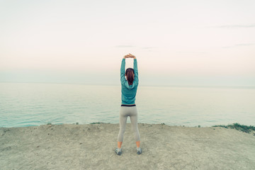 Poster - Woman stretching her arms outdoor