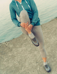 Poster - Woman stretching her legs before running