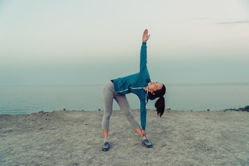 Wall Mural - Young woman stretching and preparing to run