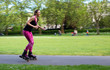 © michael spring - panning shot of a young woman rollerblading in the park