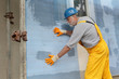 © sima - Styrofoam facade insulation, worker installing mesh, netting