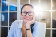 © WavebreakmediaMicro - Smiling businesswoman sitting at her desk