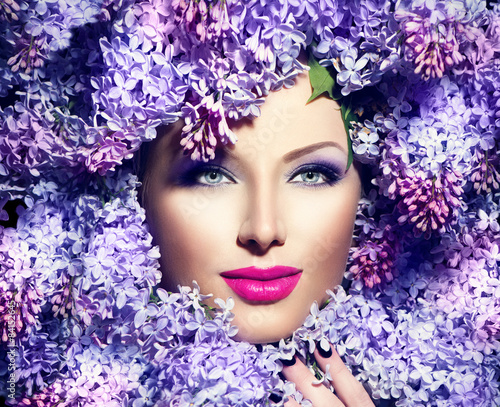 Fototapeta na wymiar Beauty fashion model girl with lilac flowers hairstyle