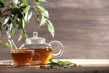 Cup of green tea on table on wooden background