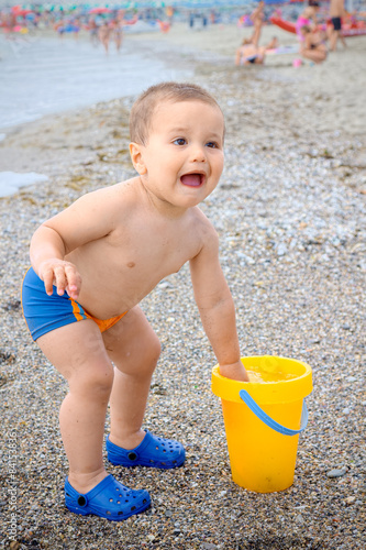 Child two year old on the beach starts crying because he dipped ...