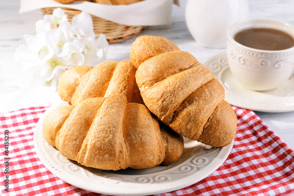 Delicious croissants on plate on table close-up