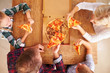 © Monkey Business - Family eating pizza together, overhead view