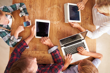 Wall Mural - Family using new technology, overhead view