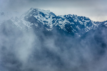  View of the snowy Olympic Mountains and low clouds from Hurrican