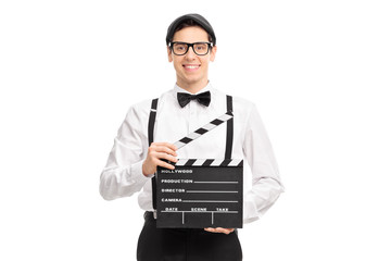 Poster - Young movie director holding a movie clapperboard, smiling and l