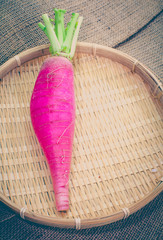 Wall Mural -  purple daikon radish in bamboo tray on fabric background