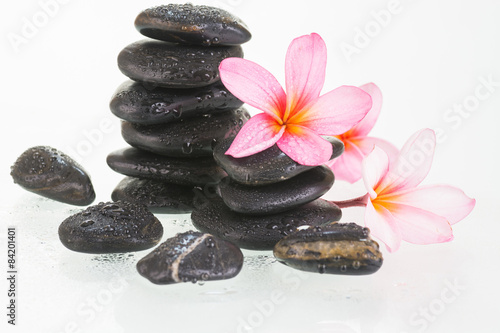 Fototapeta na wymiar Plumeria flowers and black stones close up