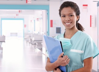 Afro american nurse at hospital with clipboard