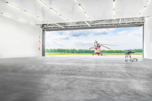 Helicopter Standing In Front Of The Hangar On A Platform.