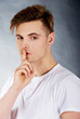 © Piotr Marcinski - Young man showing silent gesture.