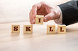 © Gajus - Businessman Arranging Blocks to Form Skill Word