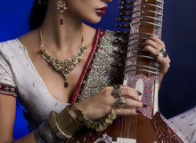 Beautiful Indian Woman In Sari With Oriental Jewelry Playing The