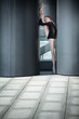 Young graceful ballerina in black bathing suit on a background o