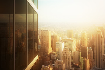 Wall Mural - Cityscape reflected in the glass of an office building at sunset
