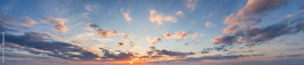 blue panorama of the sky at sunset with clouds and sun - obrazy, fototapety, plakaty 